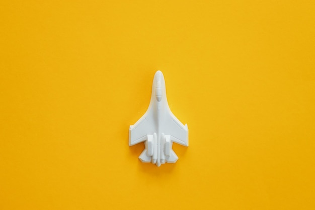 A plaster figure of a plane on a colored background