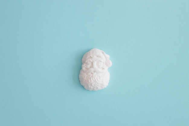 Plaster figure of Santa Claus on a colored background