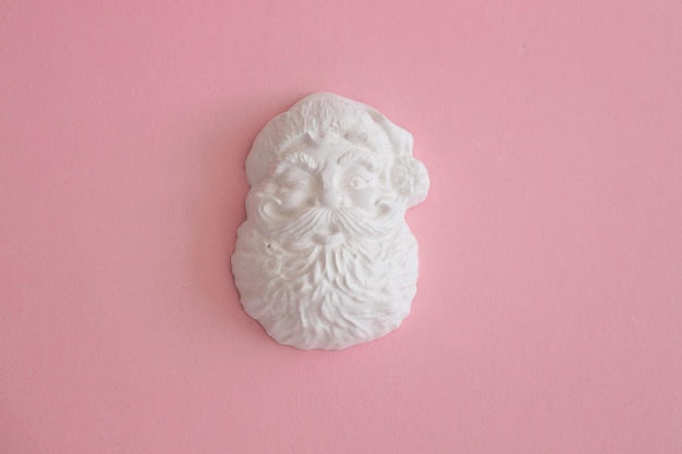 Plaster figure of Santa Claus on a colored background