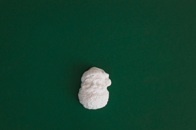 Plaster figure of Santa Claus on a colored background