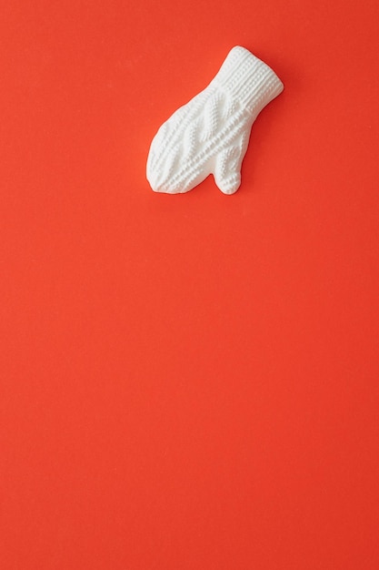 A plaster figure of a winter glove on a colored background