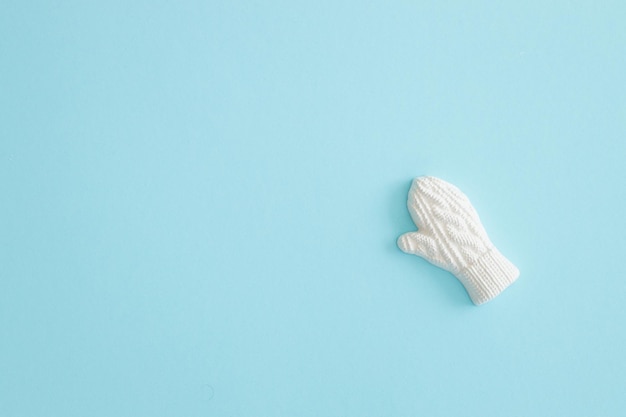 A plaster figure of a winter glove on a colored background