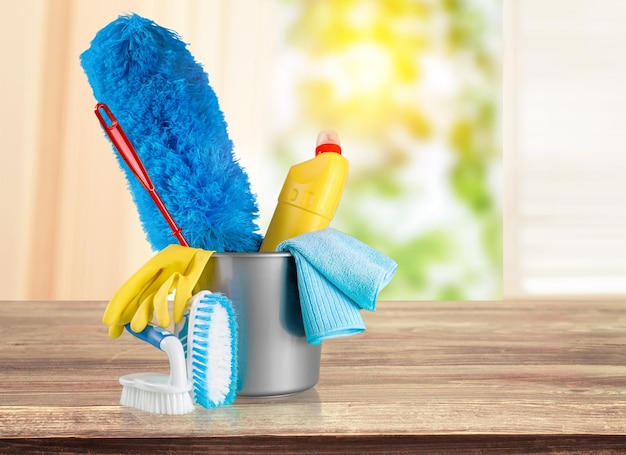 Plastic bottle, cleaning  gloves and bucket on background