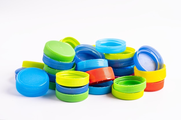 Plastic bottle colored screw caps for recycle waste on white background container water lid