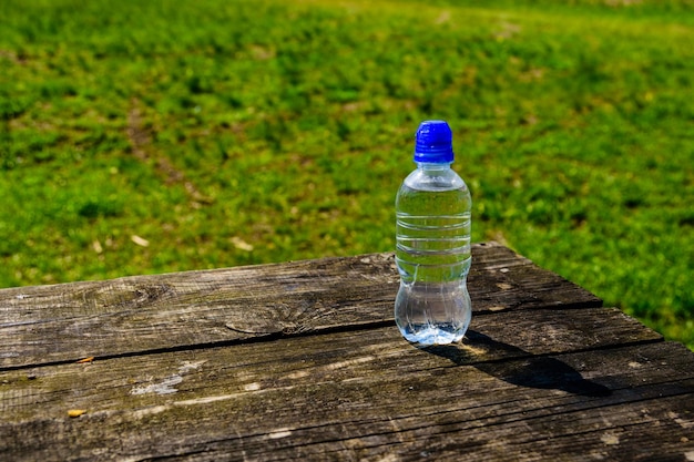 Plastic bottle with the clear water on wooden table