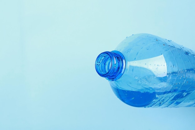 Plastic bottle with water on color background