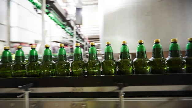 Plastic bottles for beer or carbonated beverage moving on conveyor Shallow DOF Selective focus