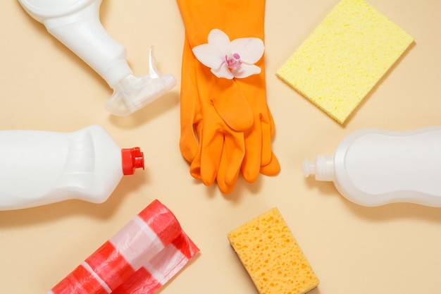 Plastic bottles of dishwashing liquid glass cleaner detergent rubber gloves garbage bags and sponges