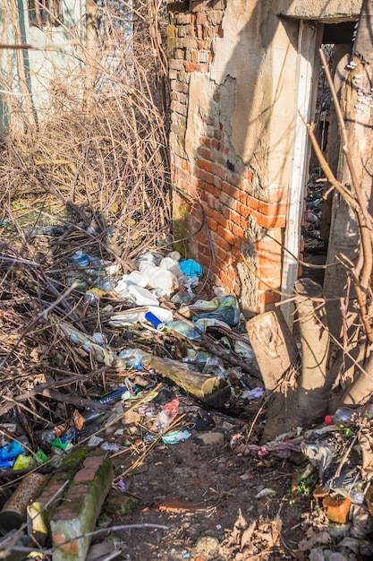 Plastic bottles and garbage near the old house Empty used dirty plastic bottles E