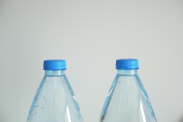 Plastic bottles of soft drink on table