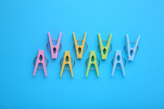 Plastic clothes pins on a blue background