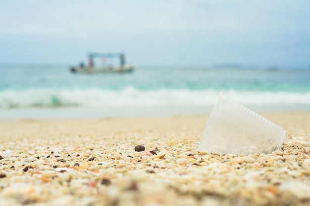 Plastic cup at the beach, recycling