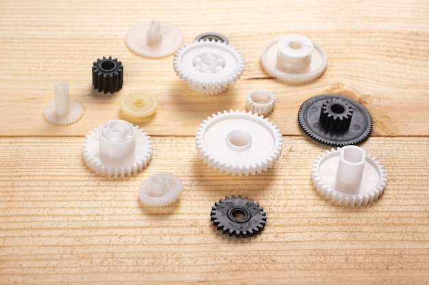 Plastic gears on a wooden background