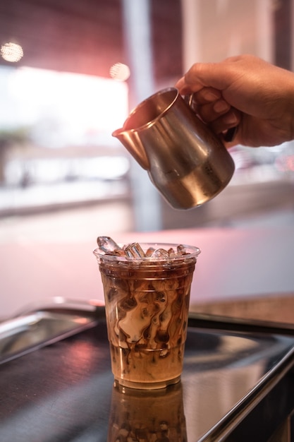 Plastic glass of coffee on the table