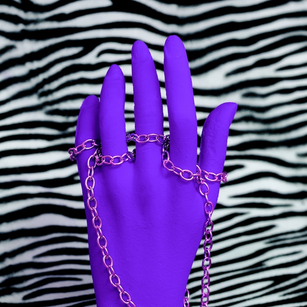 Photo plastic hand in fashion jewelry accessories on zebra print. stylish minimal concept