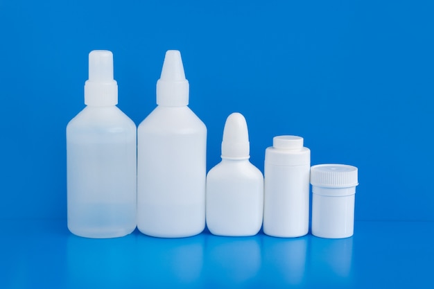 Plastic medicine containers on a blue background