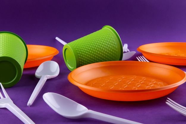 Plastic orange green waste collection on purple 