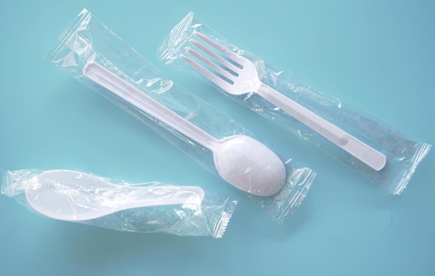 Plastic spoon and fork on table