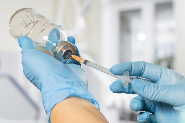 Plastic syringe and bottle for liquid medicine in hands