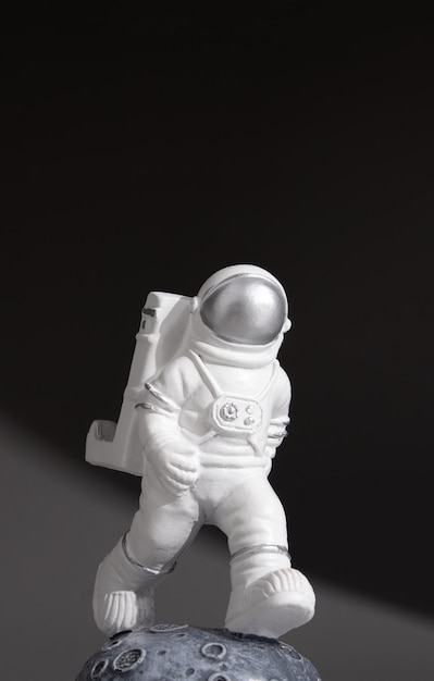 Plastic toy figure astronaut on a dark background World Space Week 2022 Space and Sustainability Closeup