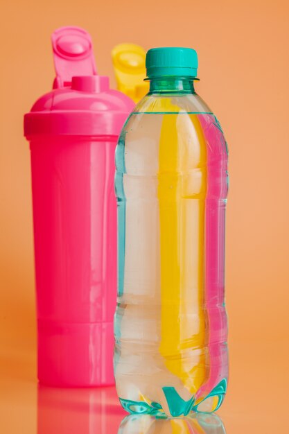 Plastic water bottles on a pastel beige background