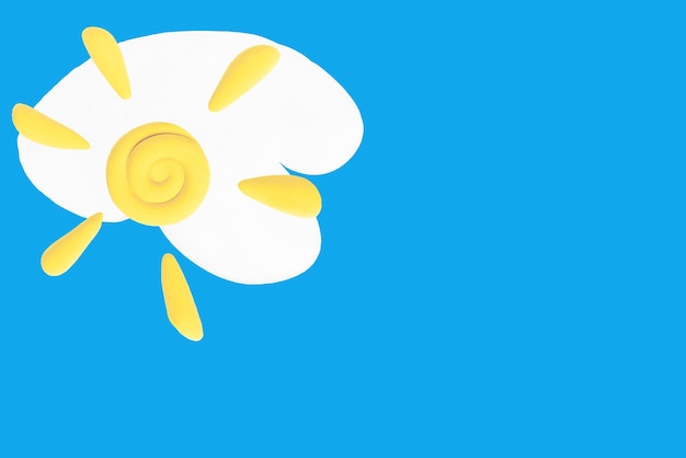 Plasticine sun on the background of clouds blue isolated background Background for kids games Place for copying