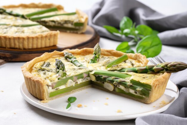 Plate of asparagus tart with flaky crust and fresh green asparagus