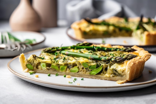 Plate of asparagus tart with flaky crust and fresh green asparagus