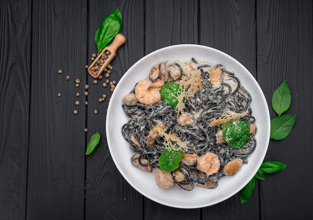 Plate of black spaghetti with prawn mussels