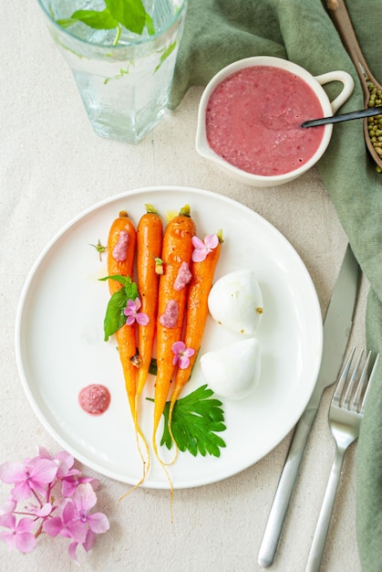 A plate of carrots with a yogurt yogurt sauce.