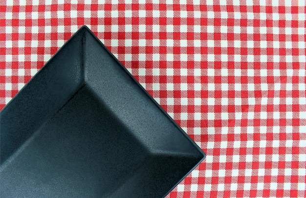 The plate on checkered tablecloth