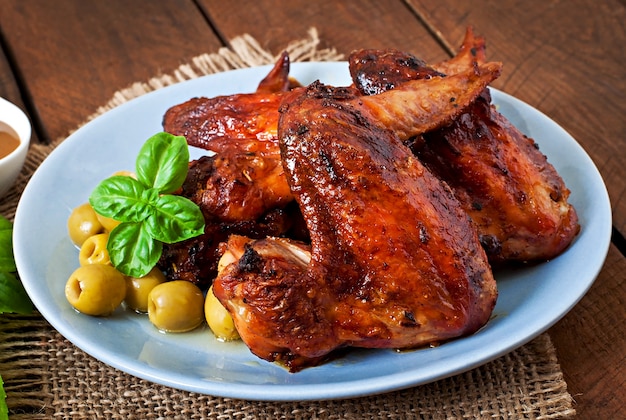 Plate of chicken wings on wooden table