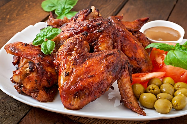 Plate of chicken wings on wooden table