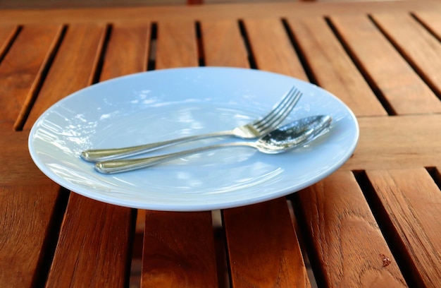 Plate and cutlery in a restaurant on a wooden table