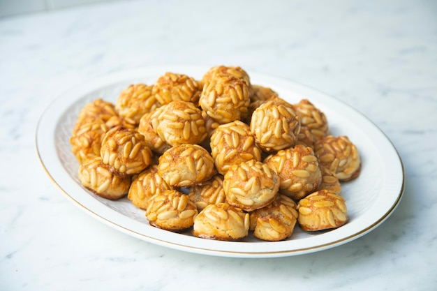 A plate of desserts with a plate of peanut butter balls.