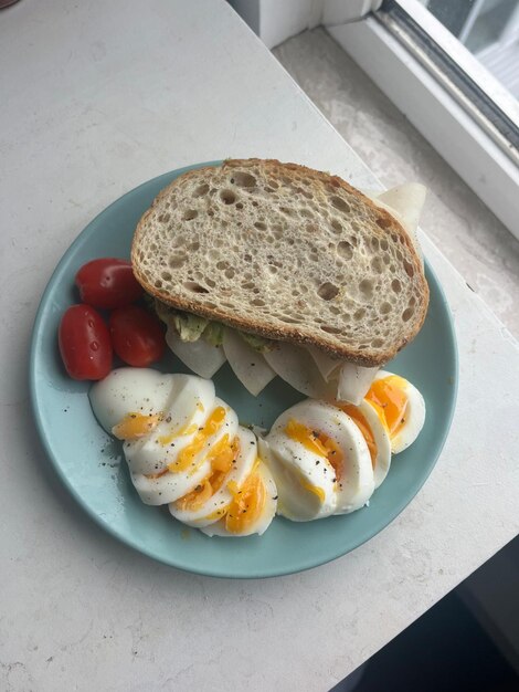 a plate of eggs eggs and toast with a slice of bread on it