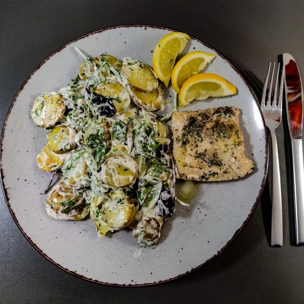 A plate of food with a fork and knife next to it