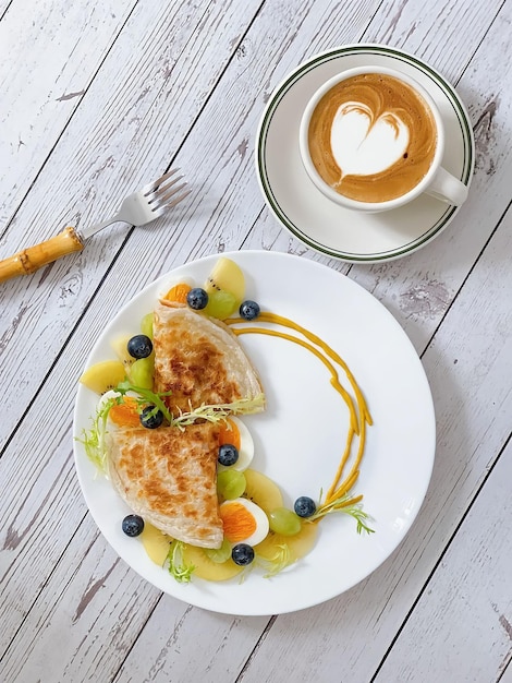 A plate of food with a heart shaped logo on it