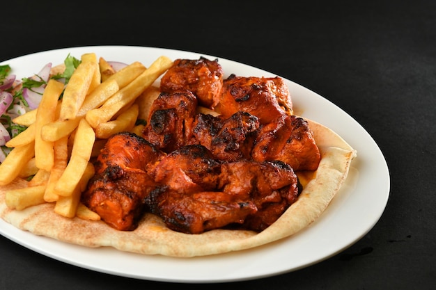 Photo a plate of food with a pita and fries