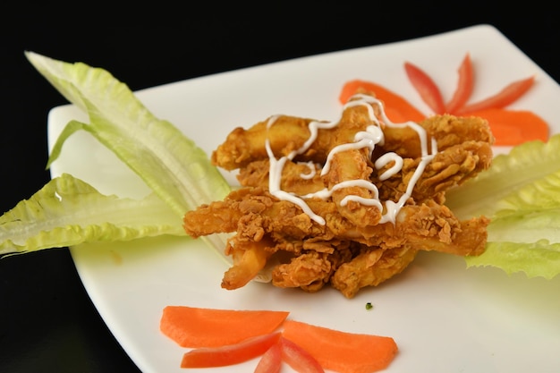 A plate of food with a plate of chicken and lettuce.