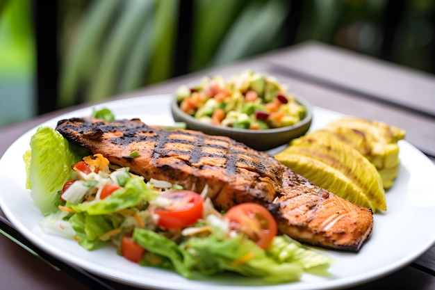 A plate of food with a salad and salmon