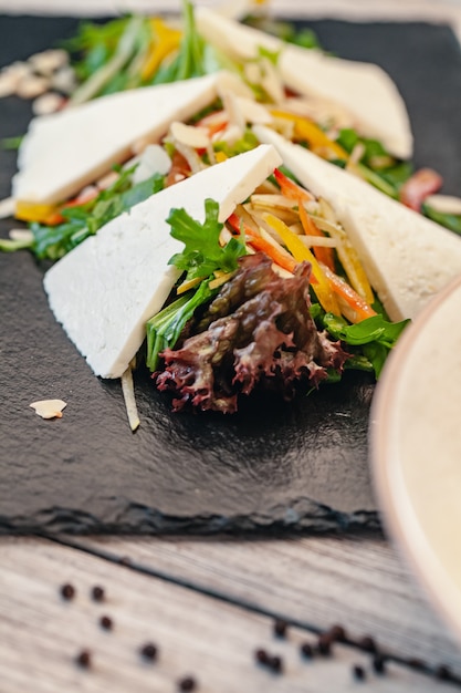 plate of green salad with vegetables and cheese