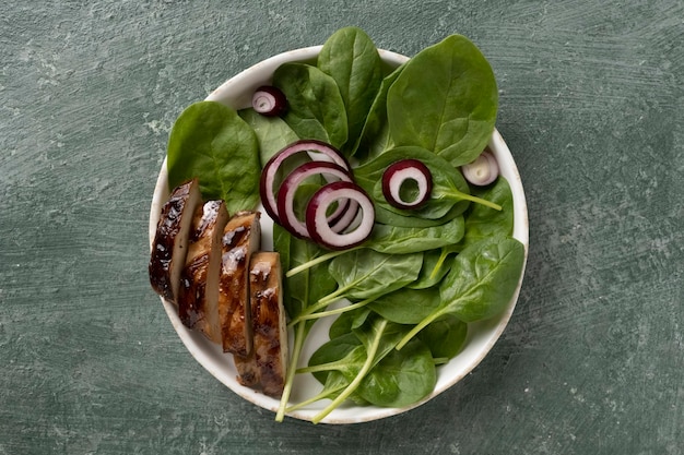 Plate grilled meat with spinach salad