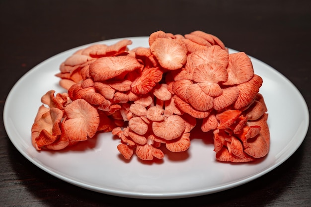 A plate of mushrooms with red flowers on it