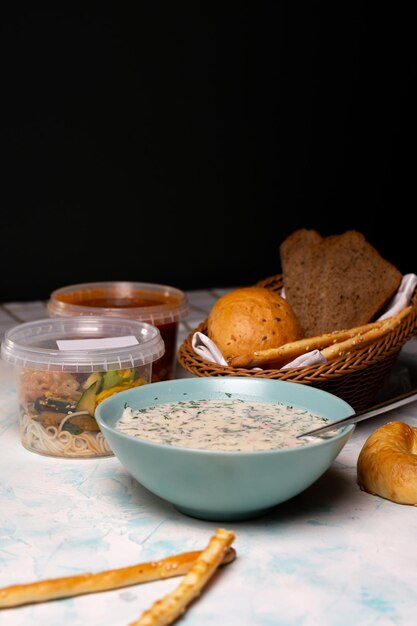 a plate of okroshka and fresh bread on the table