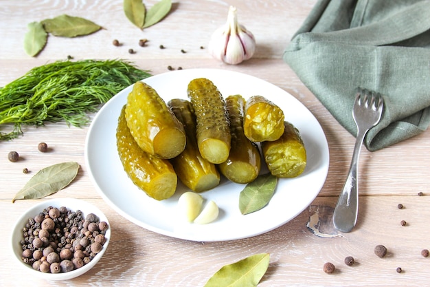 plate of pickled homemade cucumbers on wooden rustic background marinated pickled cucumbers