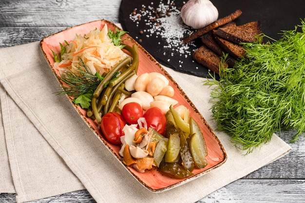 A plate of pickles a pickle snack on a wooden white background