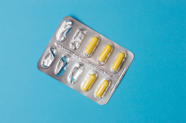 Plate of pills on a blue background