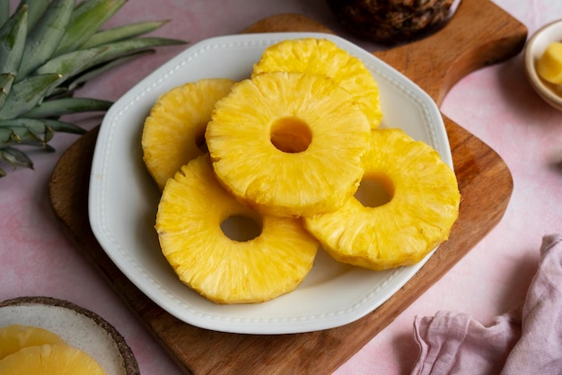 a plate of pineapples with a slice of pineapple on it