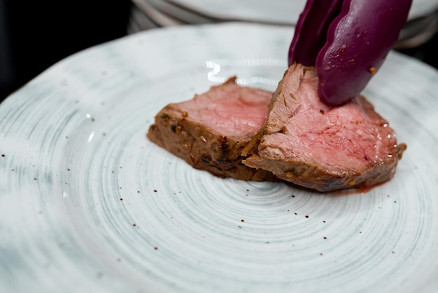 On a plate put two pieces of fried medium roasting purple tongs. High quality photo